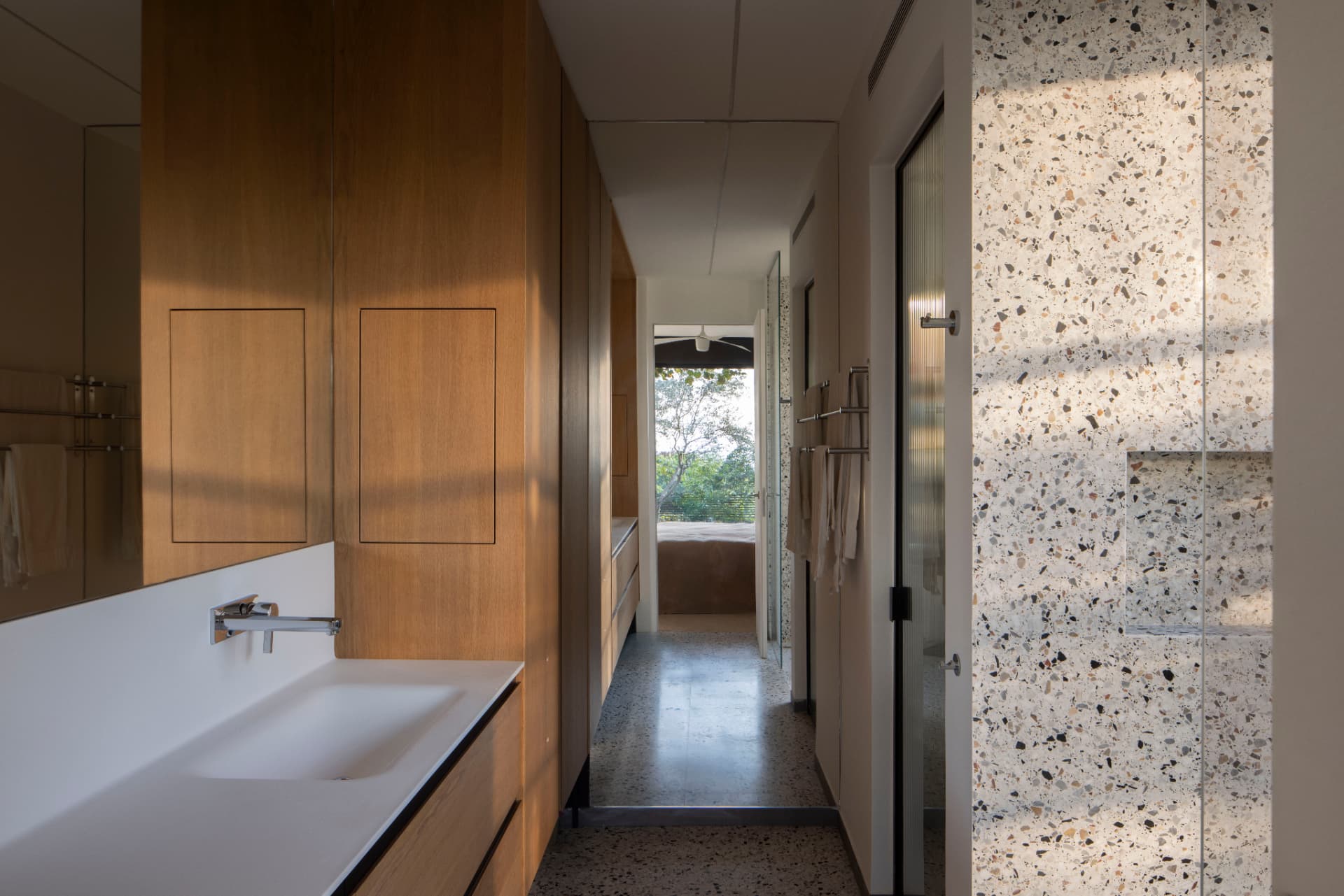 Wood vanity and terrazzo bathroom